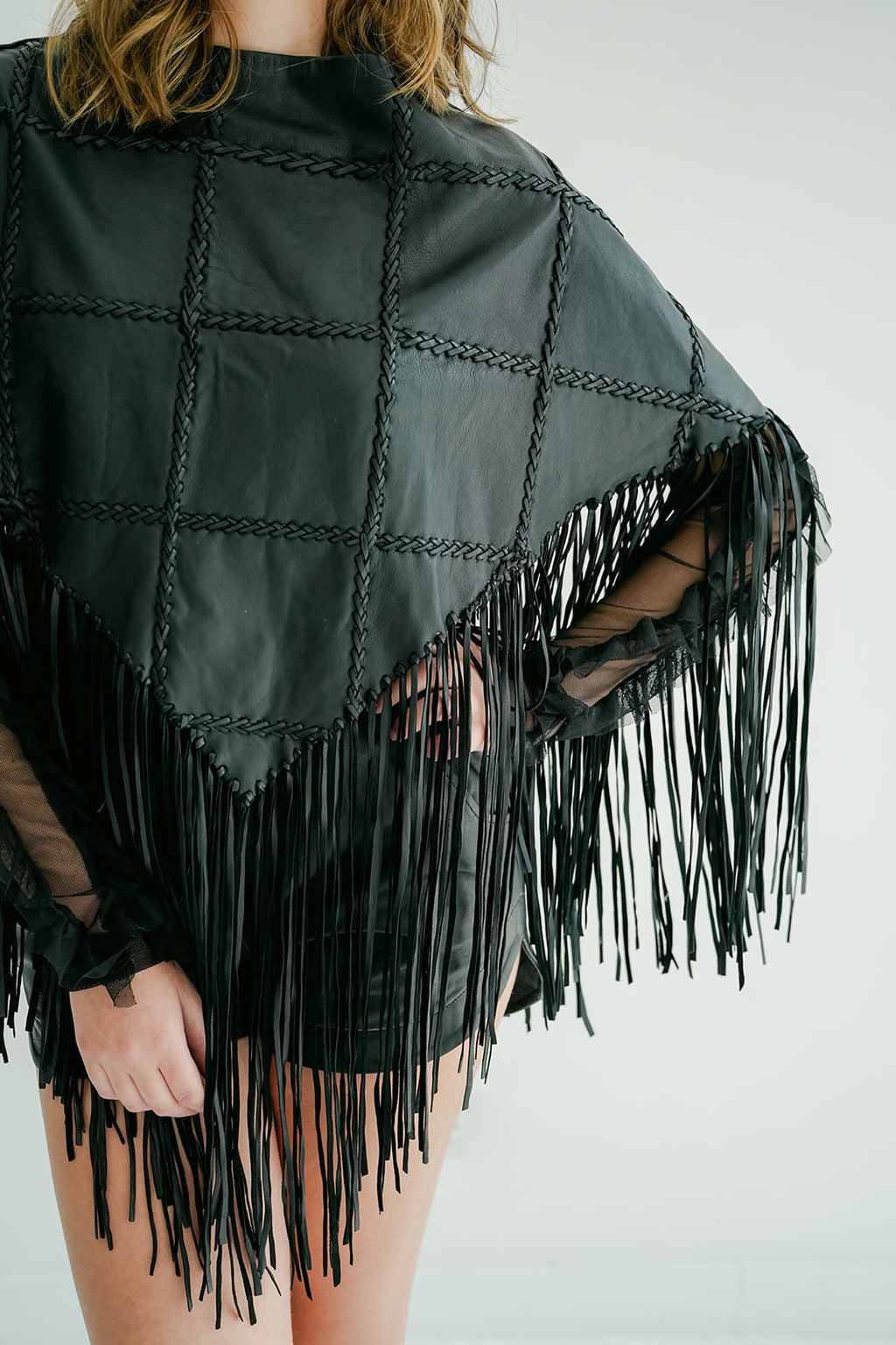 ROMPER Shoemaker poncho in black — draped detail